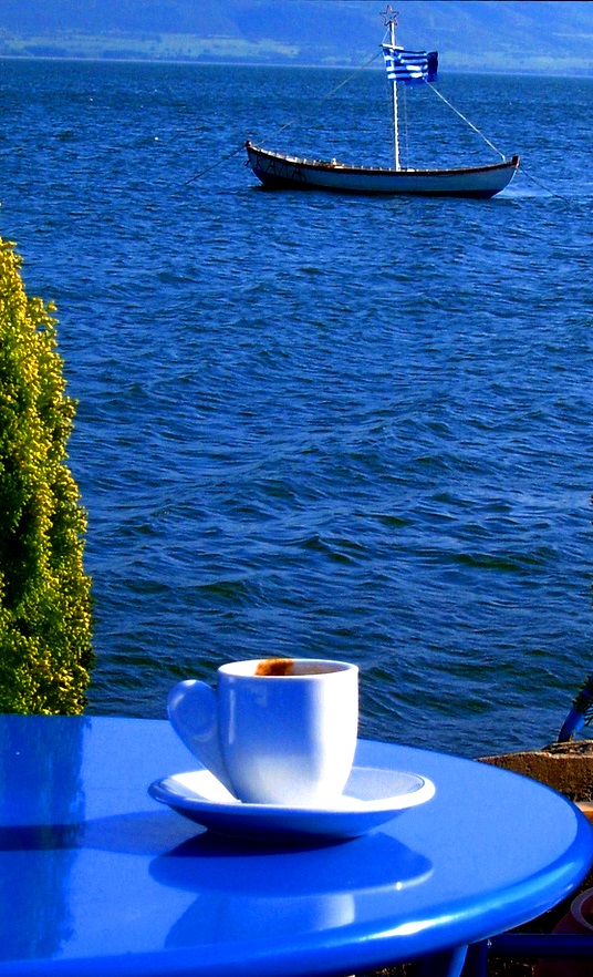 Greek coffee on a table backdropped by the infinite blue sea