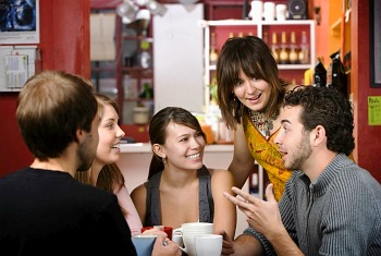 Photo of friends drinking coffee and discussing