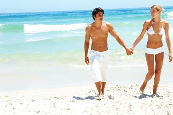 Happy couple walking on the seaside