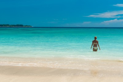 Tanned woman at exotic beach