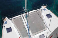 Sunbathe on deck while the catamaran sails through the Aegean Sea