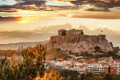 Sunset over Acropolis as the iconic monument looks imposingly over the city