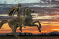 A statue of Alexander the Great overlooking the sun setting on Thessaloniki