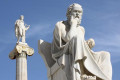 Neoclassical statues of Socrates (foreground) and Apollo (background) at the Academy of Athens