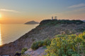 Temple of Poseidon at the edge of Cape Sounion overlooking the Aegean Sea at sunset, Attica region