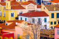 Colorful houses with ceramic rooftops in the quaint neighborhood of Plaka in the heart of Athens