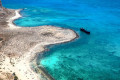 The shipwreck of Imeri Gramvousa islet within vivid turquoise waters, next to Crete island