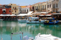 Traditional boats and seaside restaurants in the old Venetian port of Rethymnon Perfecture, Crete island