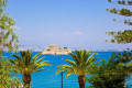 View of Bourtzi through the palm trees in the port of nafplion