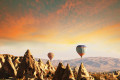 Sunset on Cappadocia while air balloons lift off