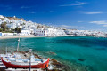 Beautiful bay with turquoise wates encircling the white washed island of Mykonos
