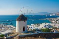 Beautiful windmill on the top of the hill overlooking Mykonos island and the Aegean Sea