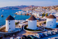 The iconic windmills of Mykonos looking over the capital