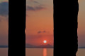 Sunset framed by the Portara, ancient gate to the Apollo's temple, Naxos island