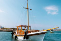 The caique sailing the Aegean on a clear summer day