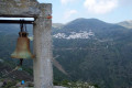 Panoramic view of Koronida village in Naxos with a church bell in the foreground