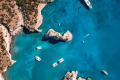 Drone view of the coast of Milos and its azure waters