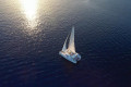The catamaran sailing during sunset