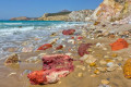 View of the colorful volcanic rocks and the golden sand of exotic Firiplaka beach, Milos island