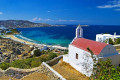 Panoramic view of the Mykonian landscape from on top a hill with a traditional church