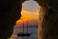 Sunset in Mykonos as a motorboat sails by