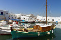 Traditional Greek boats and white houses at Parikia port, Paros island
