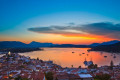 Sunset over Poros while sailboat populate its bay