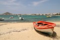 Red and white boat on the beach next to the blue sea, Naxos island