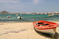 Red and white boat on the beach next to the blue sea, Naxos island