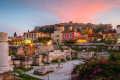 Remains of Hadrian's Library with a view of the Acropolis at dusk