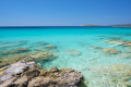 Crystal clear waters on a rocky beach in Paros