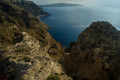 The rocky cliffs of Santorini juxtapose the serenity of the volcanic caldera below