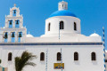 Traditional Orthodox church with a multiple cupolas in the village of Oia, Santorini