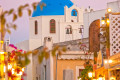 Romantic picturesque alley in Oia town at dusk, Santorini island