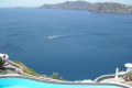 Pool, caldera and the Aegean sea, a stunning view from Oia in Santorini