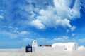 White washed alley and a blue door against the clear blue sky, Santorini island