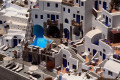 Sugar cubed houses of unique Cycladic architecture with pool, Santorini island