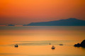 A beautiful golden hue fills the sky as the sun sets in Santorini