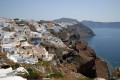 View of houses perched on the volcanic cliff overlooking the astonishing caldera, Santorini island