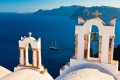 Church bell towers and the vivid blue Aegean sea, Santorini island