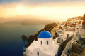 Blue-domed church in Oia, Santorini during sunset