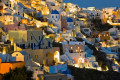 Oia dresses up to welcome the night as the sun goes down in Santorini