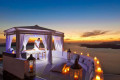 Relax in Santorini with a spa session while overlooking the stunning caldera below