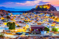 The whitewashed village of Lindos in Rhodes looks wonderful as the night falls