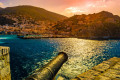 Sunset in Hydra with a view of the cannons in the port
