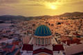 Sunset on Hermoupolis with the dome of the church of Agios Nikolaos in the foreground