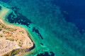 Wild coastline with clear, turquoise waters in Aigina