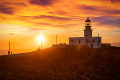 The Venetian lighthouse in Santorini watching the sun set in a golden hue of splendor