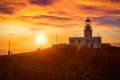 A golden sunset on the lighthouse of Armenistis in Mykonos