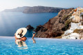 In an infinity pool in Oia, gazing at the stunning caldera below